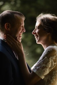 Couple looking lovingly at each other and backlit